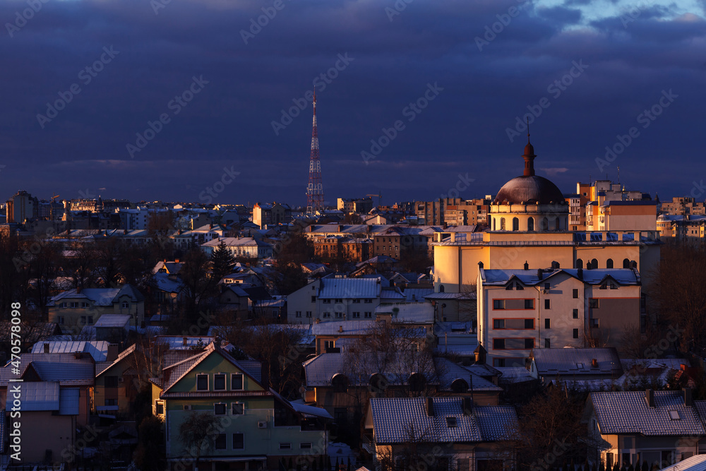 Winter cityscape. Winter City Top View Sunrise. City panorama in winter with snow in house roofs. 