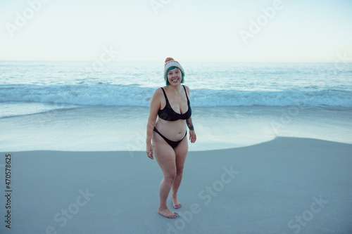 Carefree winter bather smiling at the camera at the beach