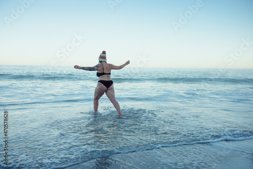 Woman enjoying the cold sea water at the beach