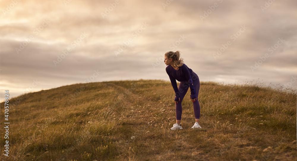 Sportswoman relaxing during running in nature