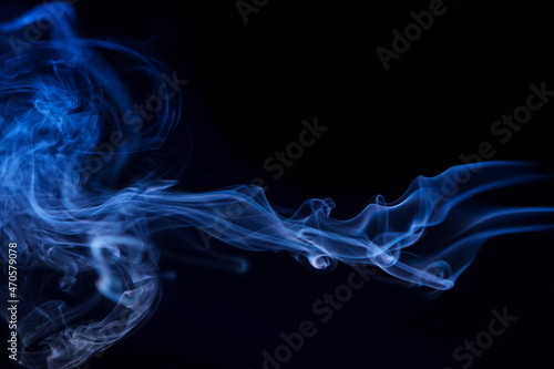 Abstract smoke Weipa. Personal aroma vaporizers. Concept of alternative non-nicotine smoking. Color vape smoke on dark background. Electronic Cigarette. Evaporator. Steaming. Blurry image, soft focus