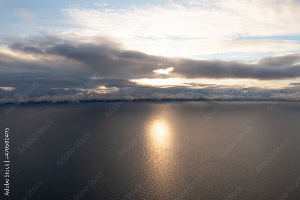 Aerial view clouds over the sea. View from drone. Aerial top view cloudscape. Texture of clouds. View from above. Sunrise or sunset over clouds. Aerial ocean background
