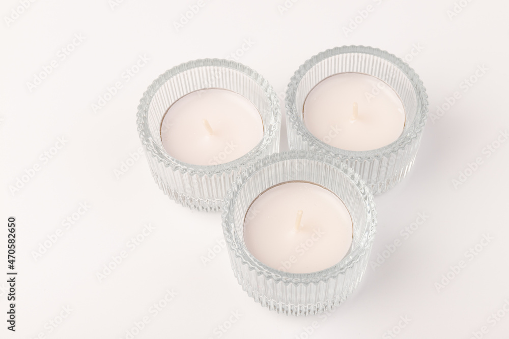 Many wax candles together on the white background Many wax candles together on the white background