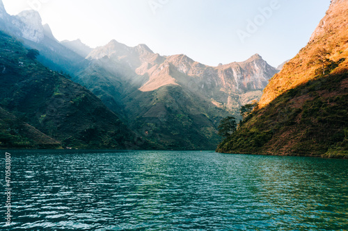 Sunlight shines through the mountains into the river in Ha Giang  Vietnam