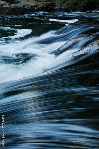 water flowing into the blue river water long exposure