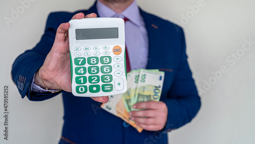 business man hold euro money and calculator