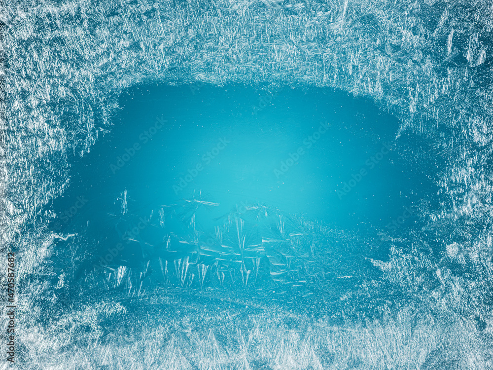 Frost patterns on frozen winter window as a symbol of Christmas wonder. Christmas or New year background. Frost patterns on frozen winter window as a symbol of Christmas wonder. Christmas or New year background.