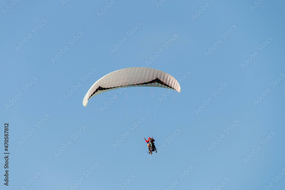 Twin paraglider. Paragliding against the blue sky. Twin paraglider. Paragliding against the blue sky.