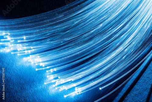 Bundle of optical fibers with lights in the ends. Blue background. photo