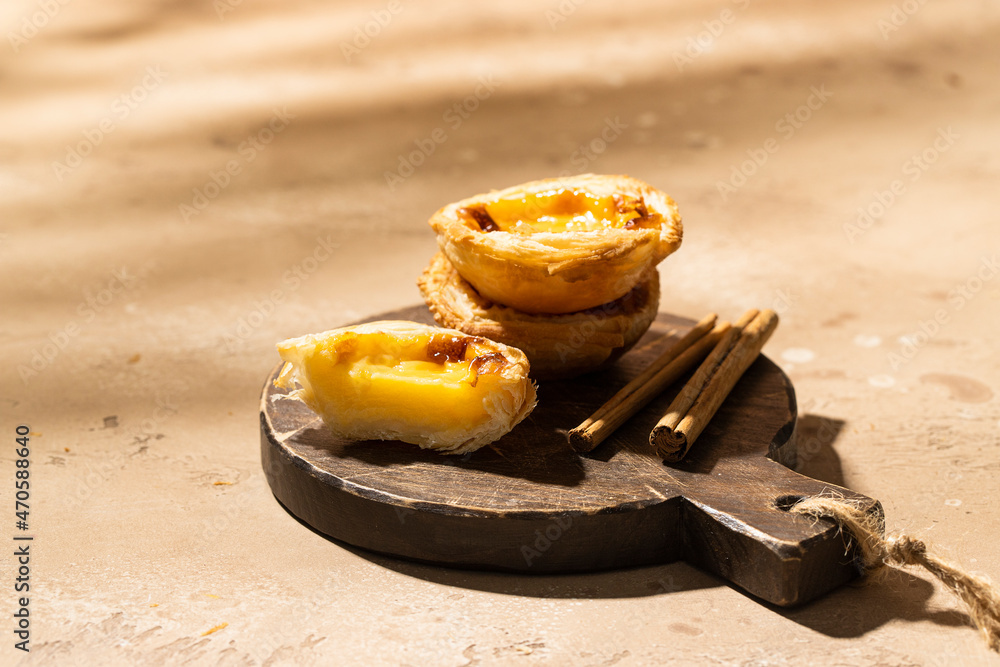 Portuguese egg custard tart pastry dusted with cinnamon. Pasteis