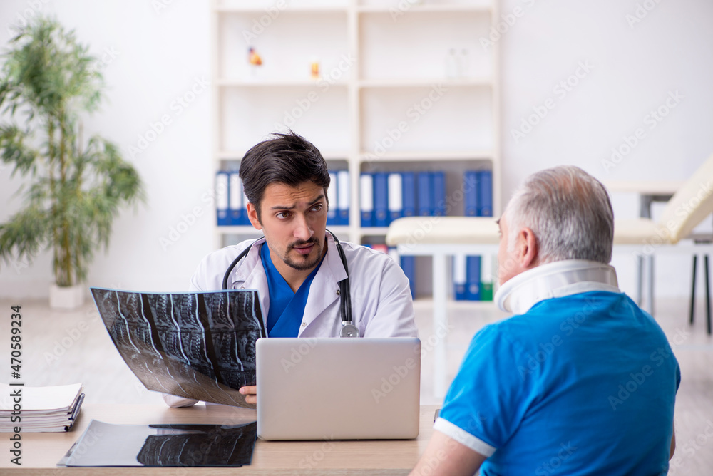 Old male patient visiting young male doctor radiologist Old male patient visiting young male doctor radiologist