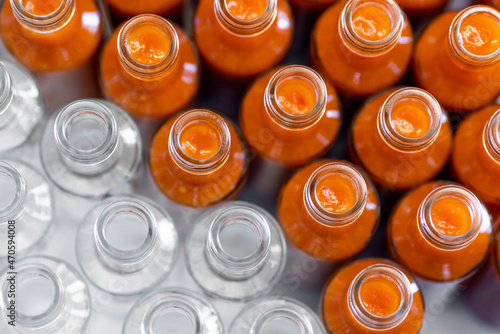 Chili sauce bottles arranged side by side in production factory
