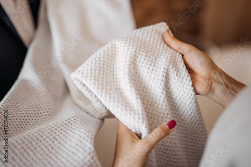 Woman checking fabric of clothes in shop photo
