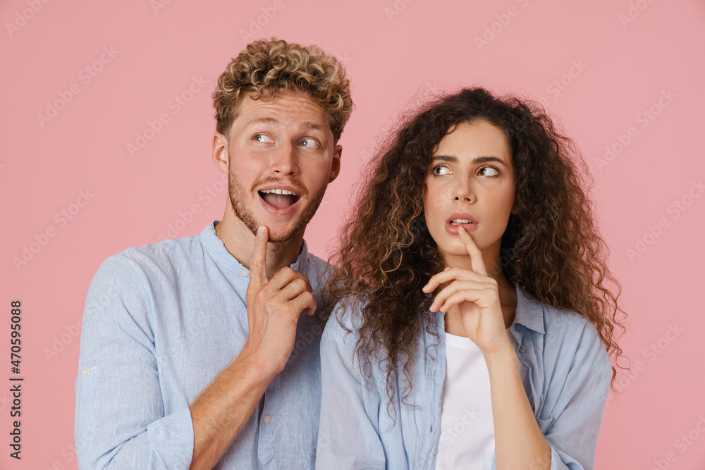 Young white man and woman gesturing while looking aside Young white man and woman gesturing while looking aside