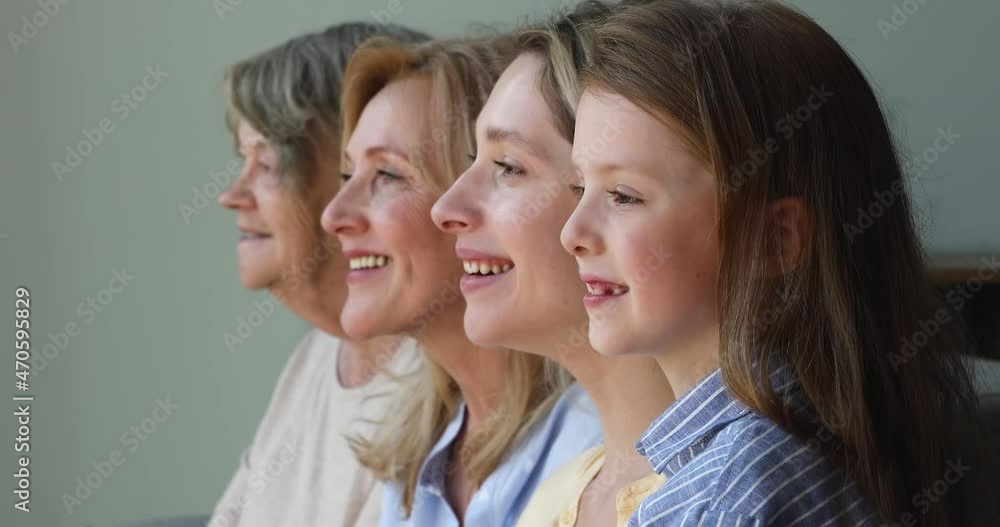 Side view smiling similar faces of little girl millennial mom middle aged granny senior adult great grandma look forward. Close up portrait multigenerational family 4 diverse age females pose in line Side view smiling similar faces of little girl millennial mom middle aged granny senior adult great grandma look forward. Close up portrait multigenerational family 4 diverse age females pose in line