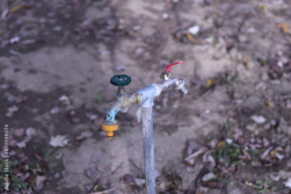 a tap from which water can be drained on two sides a tap from which water can be drained on two sides