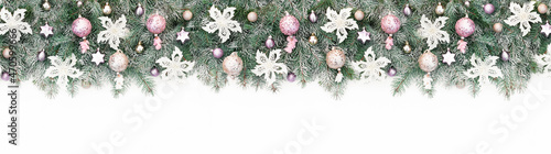 Long banner with Christmas tree garland decorated with pink and gold glitter balls  white flowers. Background with pastel Christmas baubles close up for design template with copy space.