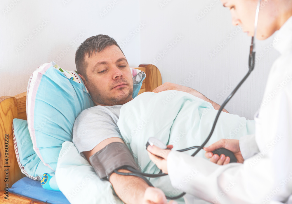 The nurse measures the patient's blood pressure. Selective focus. The nurse measures the patient's blood pressure. Selective focus.