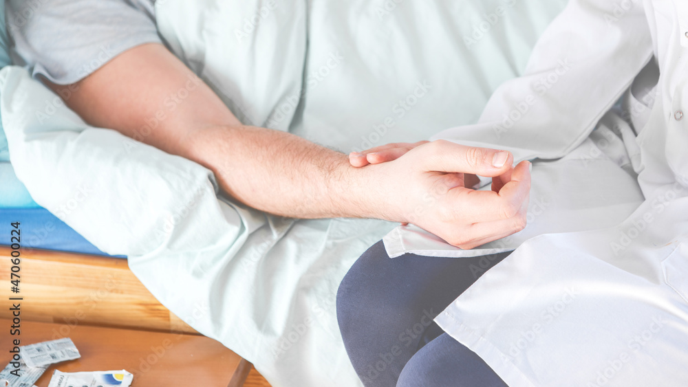 The doctor examines the patient\'s pulse by hand and records the results, health medical checkup concept The doctor examines the patient\'s pulse by hand and records the results, health medical checkup concept