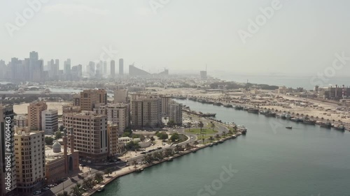 Wallpaper Mural Aerial view of Sharjah UAE cityscape. A city on the shores of the Arabian Sea with modern smog architecture on the roads and high-rise buildings in downtown. Torontodigital.ca