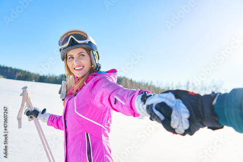 Young couple having fun while winter skiing
