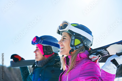 Young couple having fun while winter skiing