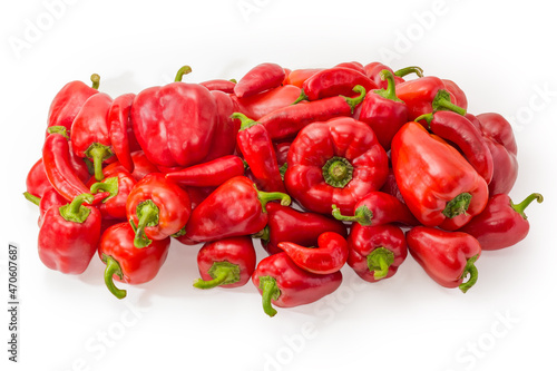 Heap of red bell peppers and chili on white background