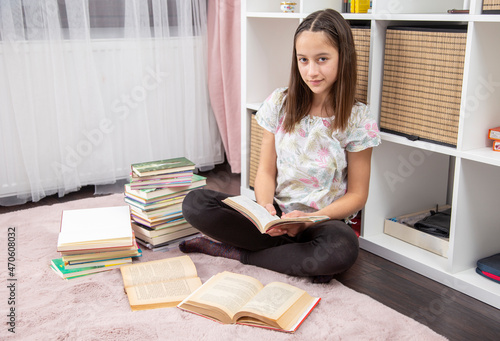 Teenager girl in her room, read a book