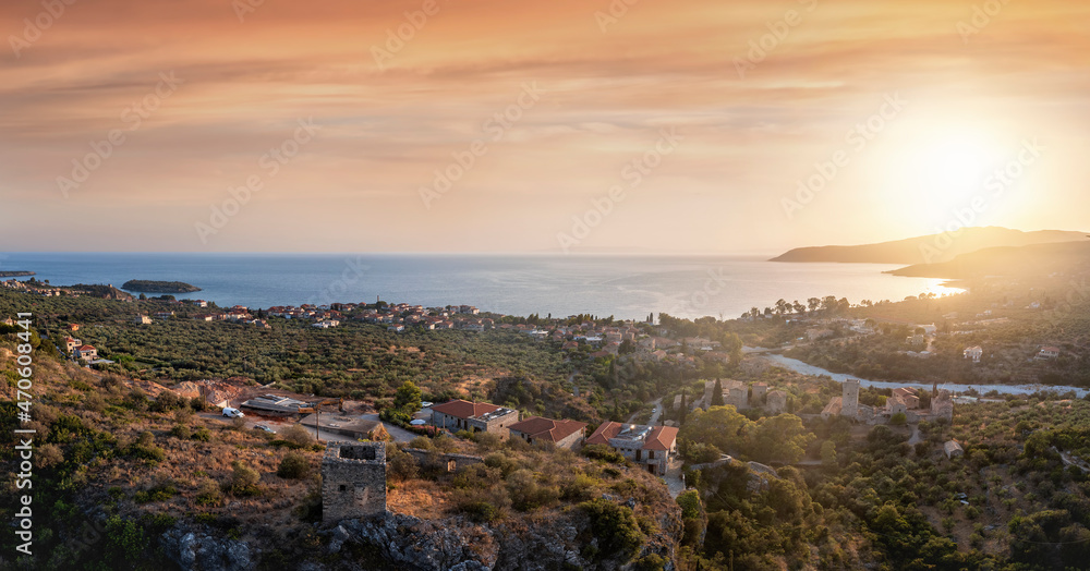 Panoramic aerial summer sunset view of the bay and town of Kardamyli, Lakonia, Mani, Greece, with the historic old town and riverbed