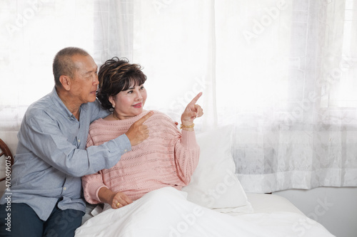 Portrait of nice couple senior asia woman and retirement man on the bed