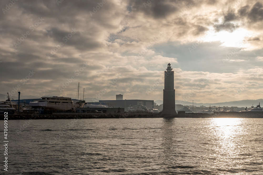 The ancient lighthouse of the port of Livorno, Italy, against a dramatic sky