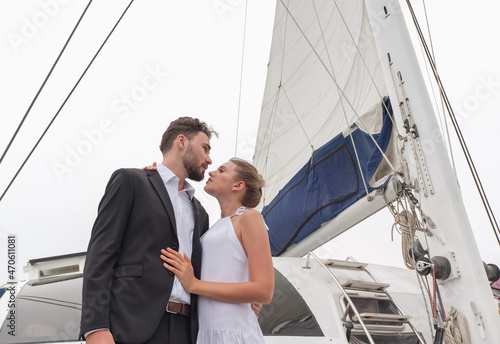 Portrait caucasian couple in love on luxury white yacht in ocean