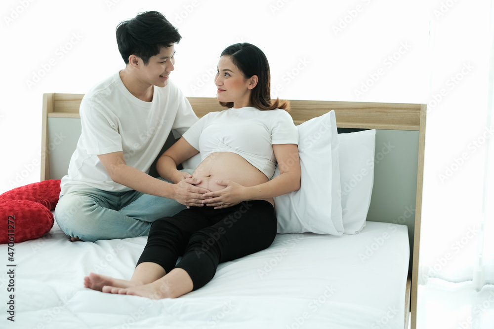 portrait asia young pregnant woman and husband happy together on the bed portrait asia young pregnant woman and husband happy together on the bed