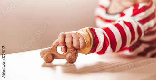 Little boy playing with wood car indoor