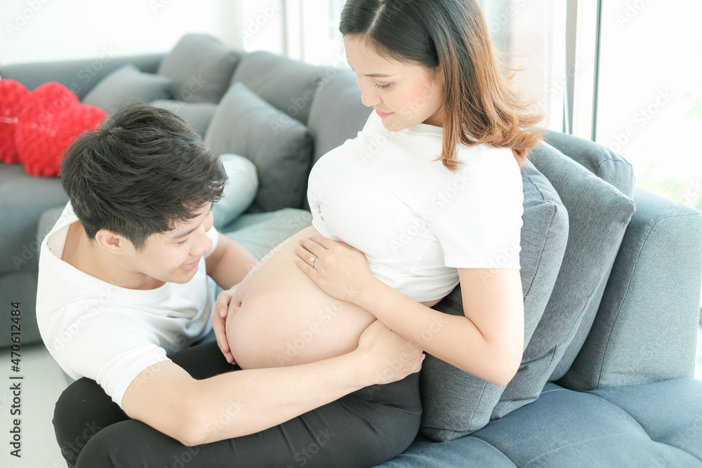 portrait asia young pregnant woman and husband happy together on sofa portrait asia young pregnant woman and husband happy together on sofa