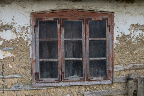 Sunja,Croatia,05,04,2021. Rustic style aged window in wooden village rural home wall. © A1