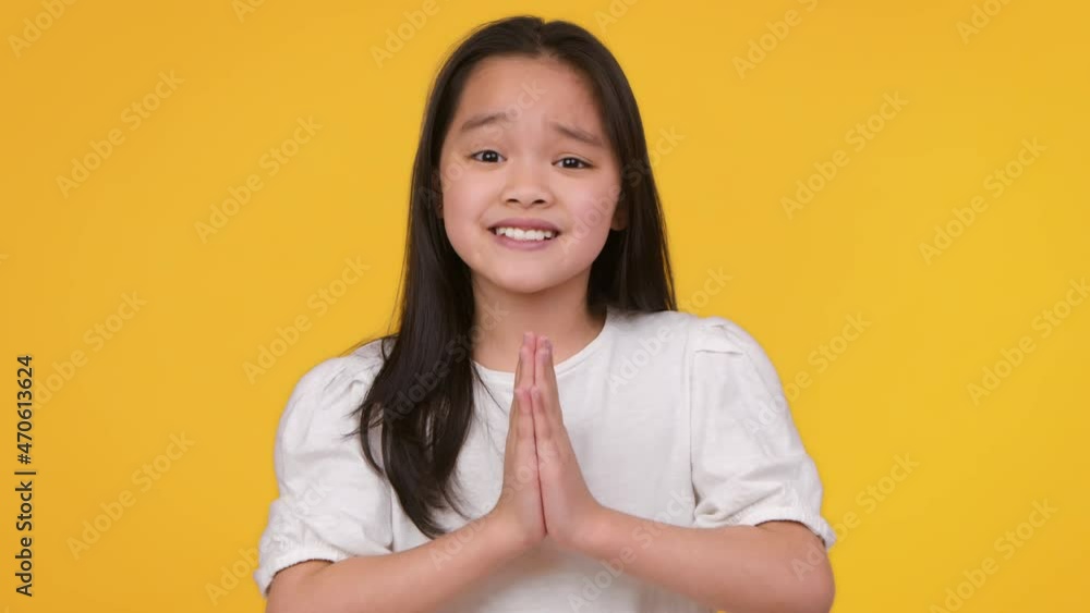 Please, please. Studio portrait of cute little asian girl begging and pleading to camera, asking for something Please, please. Studio portrait of cute little asian girl begging and pleading to camera, asking for something