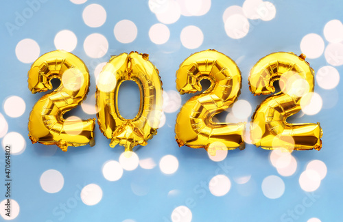 2022 new year foil balloon numbers on sparkling blue background