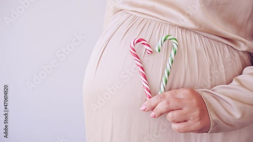 Wallpaper Mural Pregnant skin care. Morning body routine. Woman belly with candy cane. Heart shape. Female person. Anti cellulite cosmetology treatment. Waiting baby. Christmas concept Torontodigital.ca