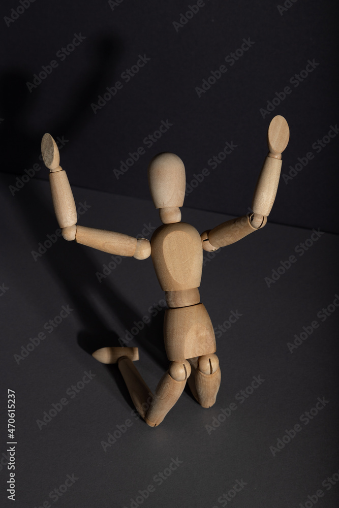 Wooden mannequin in imploration, praying position on gray background. religion concept. copy space. Wooden mannequin in imploration, praying position on gray background. religion concept. copy space.