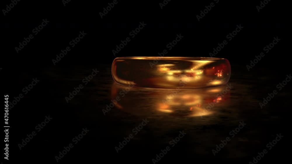 Flying around the gold ring LOVE FOREVER on the matte glass surface with reflection Flying around the gold ring LOVE FOREVER on the matte glass surface with reflection