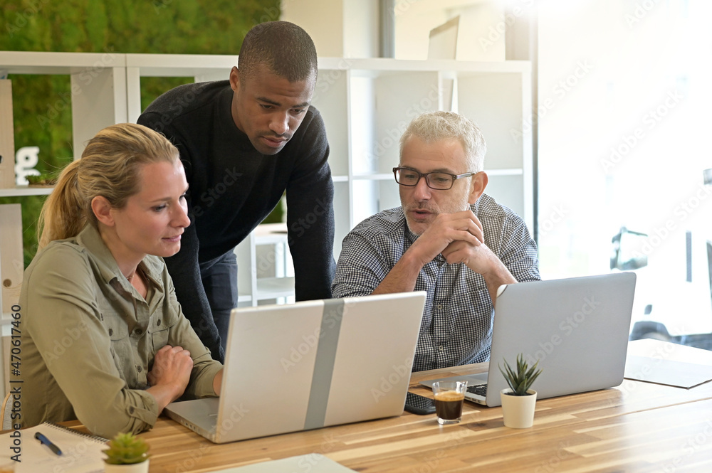 Business people in modern meeting room working together on project Business people in modern meeting room working together on project