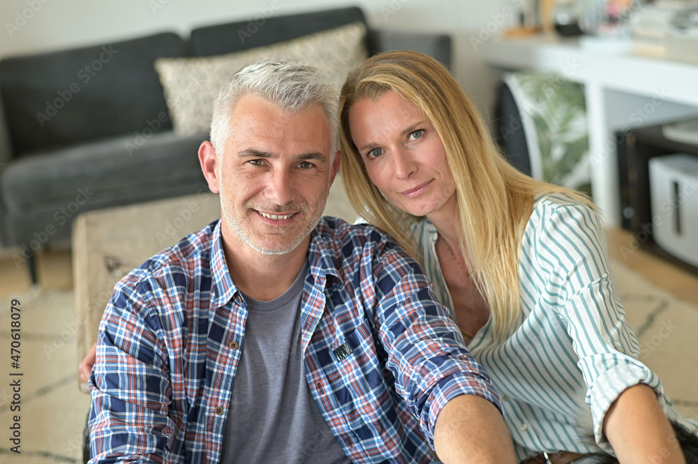 Portrait of middle-aged couple relaxing in sofa at home Portrait of middle-aged couple relaxing in sofa at home