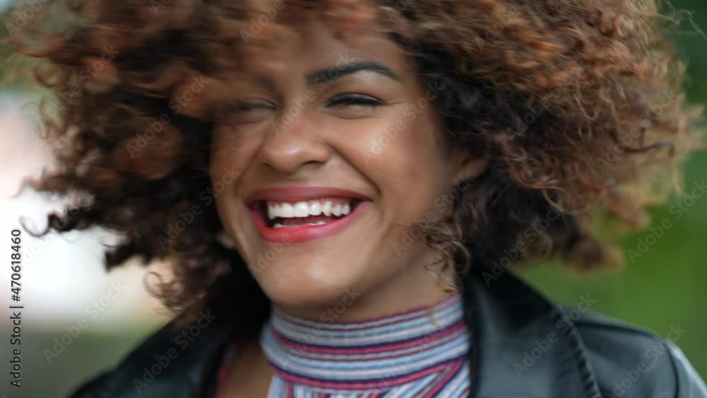 Carefree woman shaking head and curly hair, happy emotion Carefree woman shaking head and curly hair, happy emotion