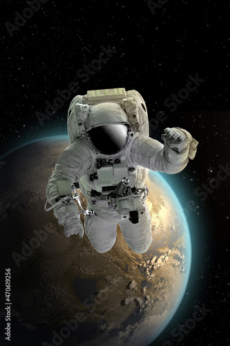 Fototapeta Naklejka Na Ścianę i Meble -  Astronaut in outer open space over the planet .Stars provide the background.erforming a space above planet Earth.Sunrise,sunset.Our home. ISS.Elements of this Image Furnished by NASA.