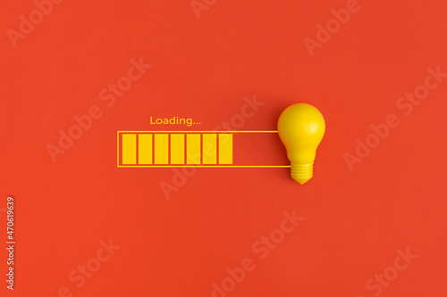 Light bulb and loading on red background. Inspiration and creative idea concept. photo