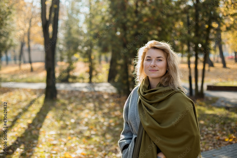 Beautiful woman wearing shawl in autumn park Beautiful woman wearing shawl in autumn park