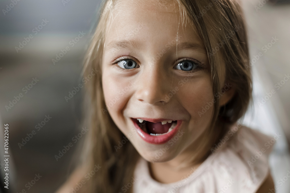 Girl smiling with gap tooth at home Girl smiling with gap tooth at home