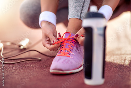 Runner tying jogging shoes