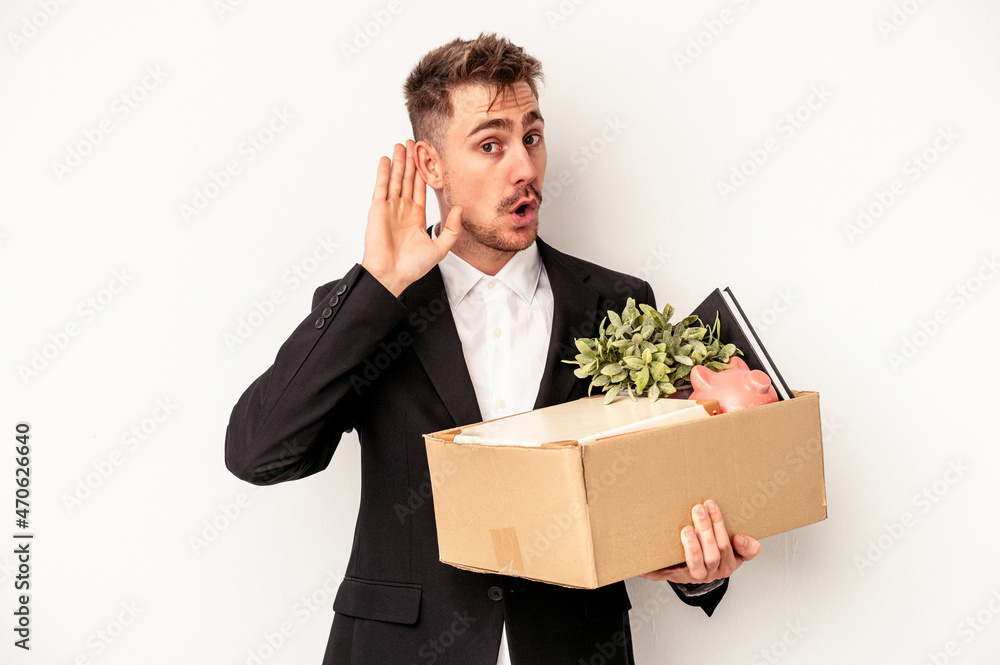 Young caucasian business man fired from job isolated on white background trying to listening a gossip. Young caucasian business man fired from job isolated on white background trying to listening a gossip.